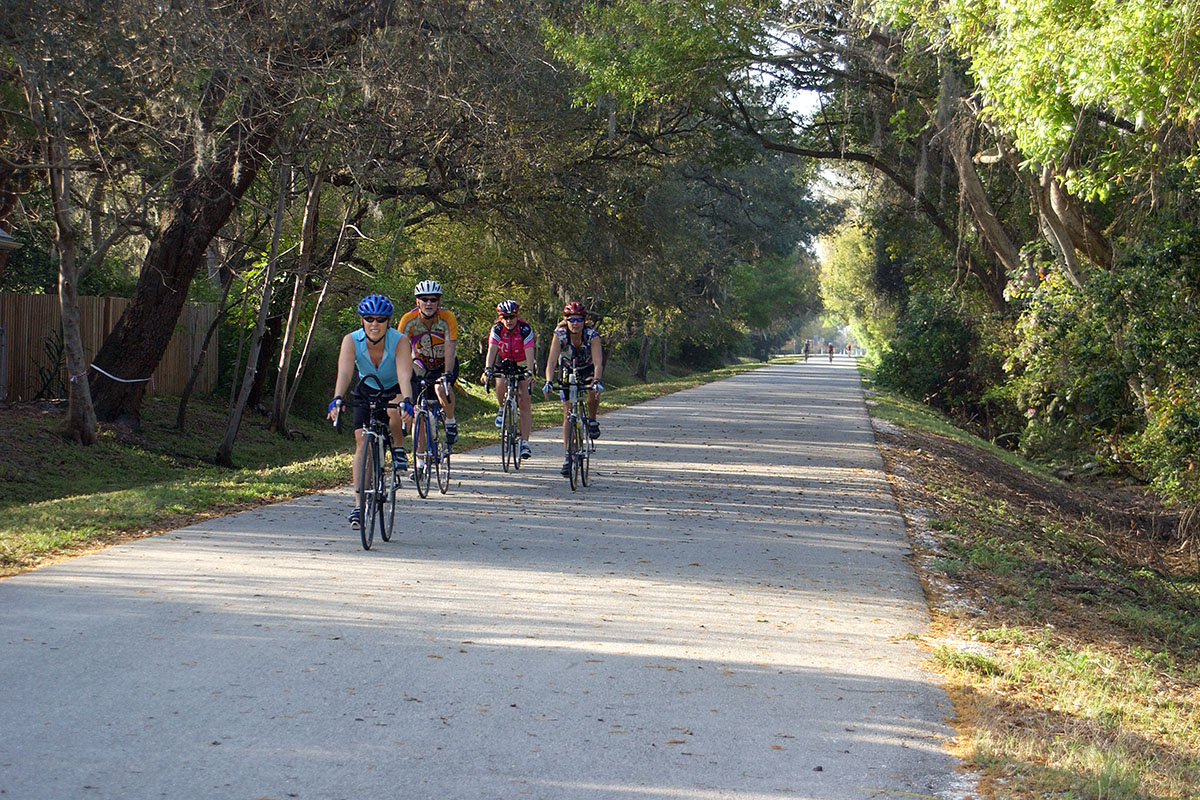 Four people riding bikes on the Pinellas Trail.