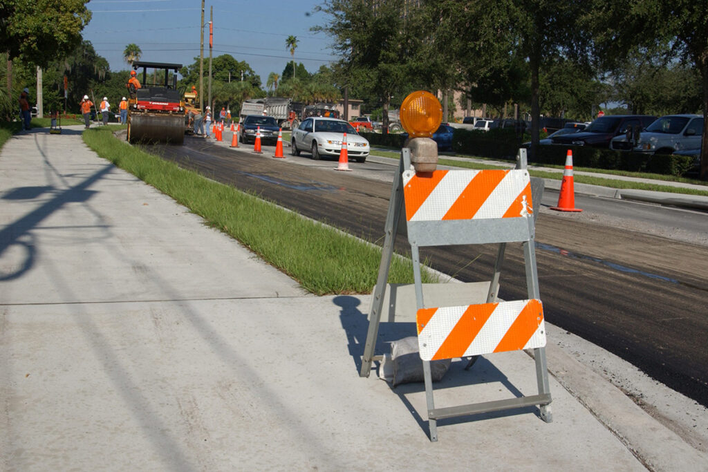 barriers and street paving equipment at work